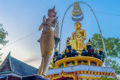 Low angle view of statue against blue sky