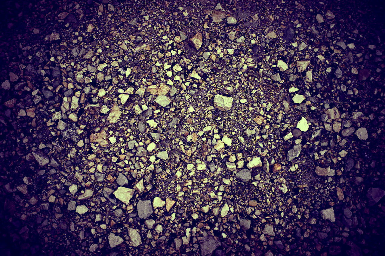 CLOSE-UP OF PEBBLES ON PEBBLE