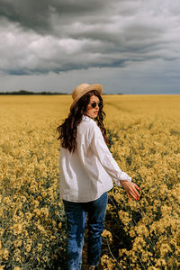 Walk in the field with flowers. yellow field with rapeseed.