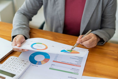 Midsection of businessman working at office