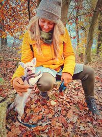 Full length of woman with leaves during autumn