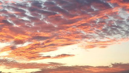 Low angle view of cloudy sky at sunset