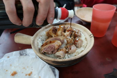 Midsection of person having food in restaurant