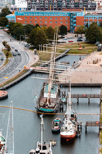 High angle view of boats moored at harbor in city