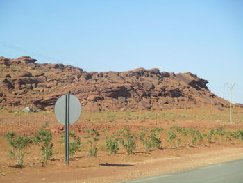 Scenic view of desert against clear blue sky