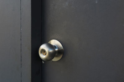 Close-up of metallic doorknob on door