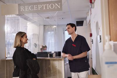 Patient and doctor at reception desk