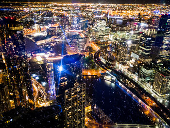 High angle view of city lit up at night