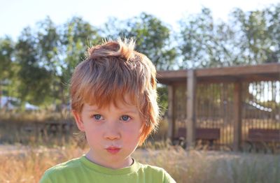 A blond boy with pouty lips and a milky mustache . the five-year-old bully stares intently 