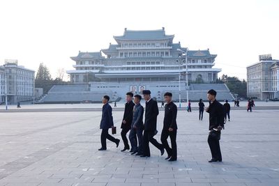 Group of people standing in front of buildings