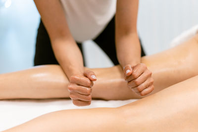 Midsection of woman sitting on floor