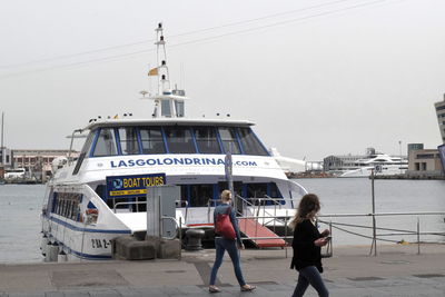 People on boat against sky