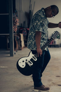 Full length of man playing guitar