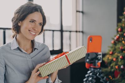 Portrait of young woman using mobile phone