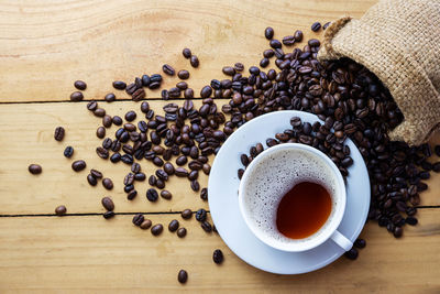 High angle view of coffee beans in cup on table