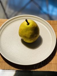 Close-up of apple in plate on table