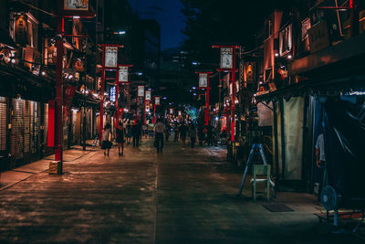 Illuminated city against sky at night