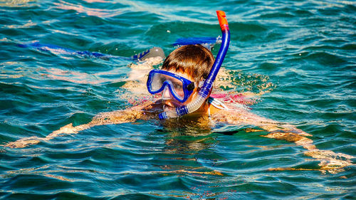 Boy swimming in sea