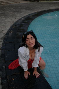 Low angle view of young woman sitting on steps