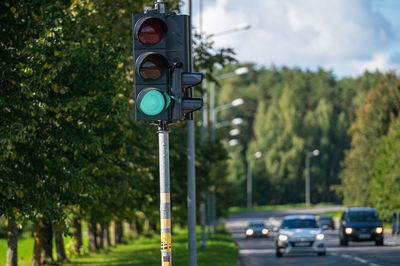 Closeup of traffic semaphore with green light on defocused city street
