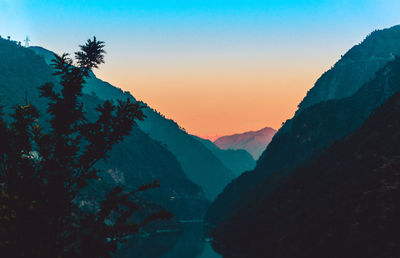 Scenic view of mountains against sky at sunset