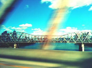 Suspension bridge against sky in city