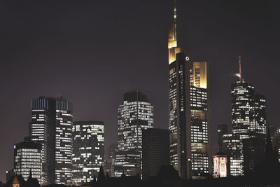 Low angle view of skyscrapers lit up at night