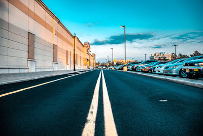 Empty road along buildings