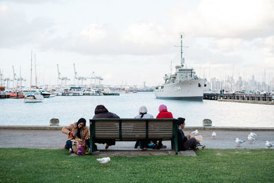 People sitting on boat against sky