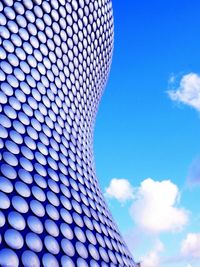 Low angle view of modern building against blue sky