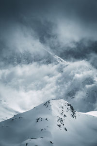 Low angle view of snowcapped mountain against sky