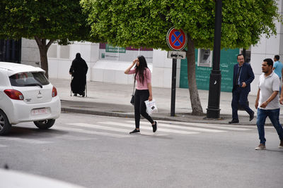 People walking on road in city