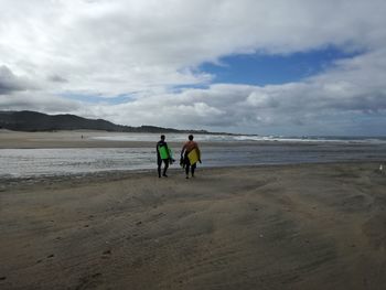 Rear view of men on beach