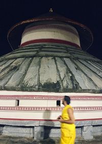 Low angle view of man with building at night