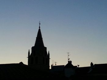 Low angle view of silhouette temple against clear sky