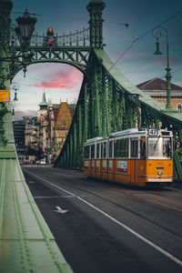 Train on railroad tracks in city against sky