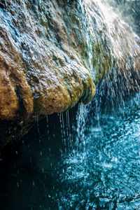 Close-up of water splashing on rock