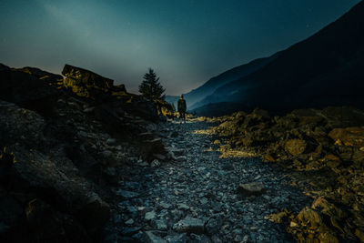 Scenic view of land against sky at night