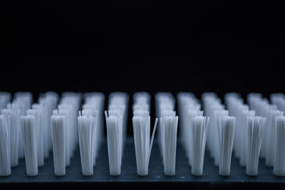 Close-up of white pencils against black background