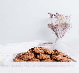 Close-up of cookies on table against white background