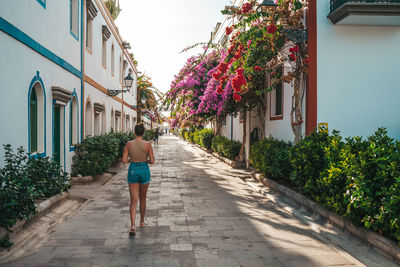 Rear view of woman walking on street