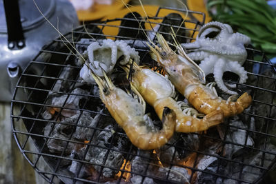 Grilled shrimp and squid on hot charcoal