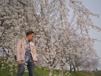 Man standing by tree