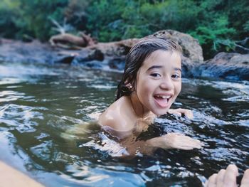 Portrait of young woman swimming in lake