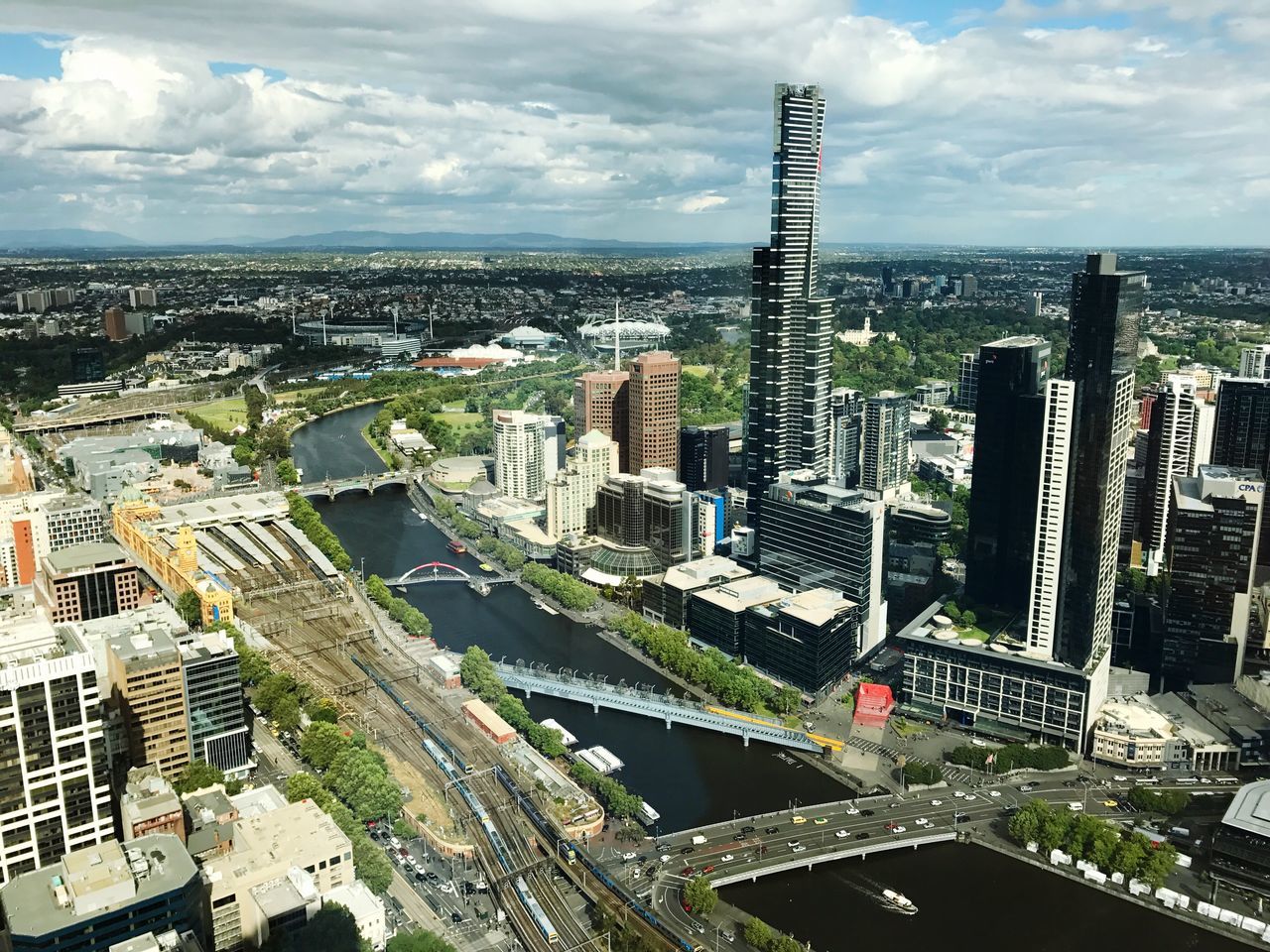 HIGH ANGLE VIEW OF CITYSCAPE AGAINST CLOUDY SKY