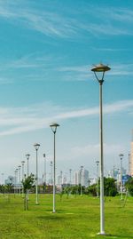 Street light on field against sky