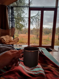 Man holding coffee cup on table