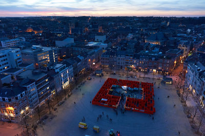 High angle view of city lit up at dusk