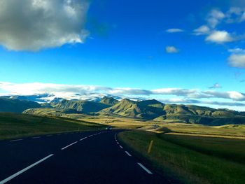 Scenic view of mountains against blue sky