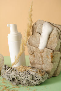 Facial product sample on a stone and spikelet. a set of cosmetics products with natural materials.